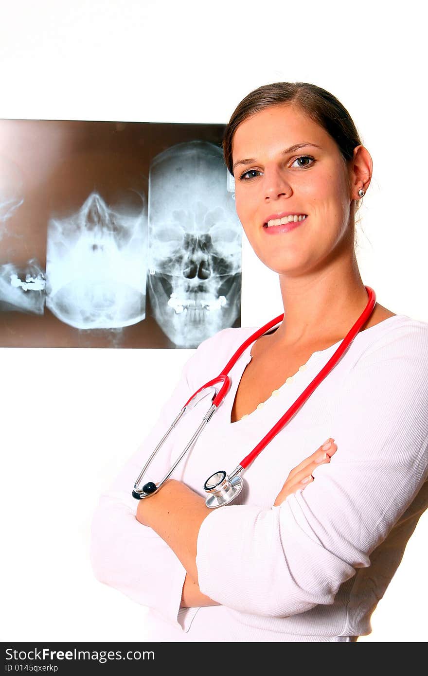 A beautiful young doctor with a red stethoscope and a xray image in the back. Isolated over white. A beautiful young doctor with a red stethoscope and a xray image in the back. Isolated over white.