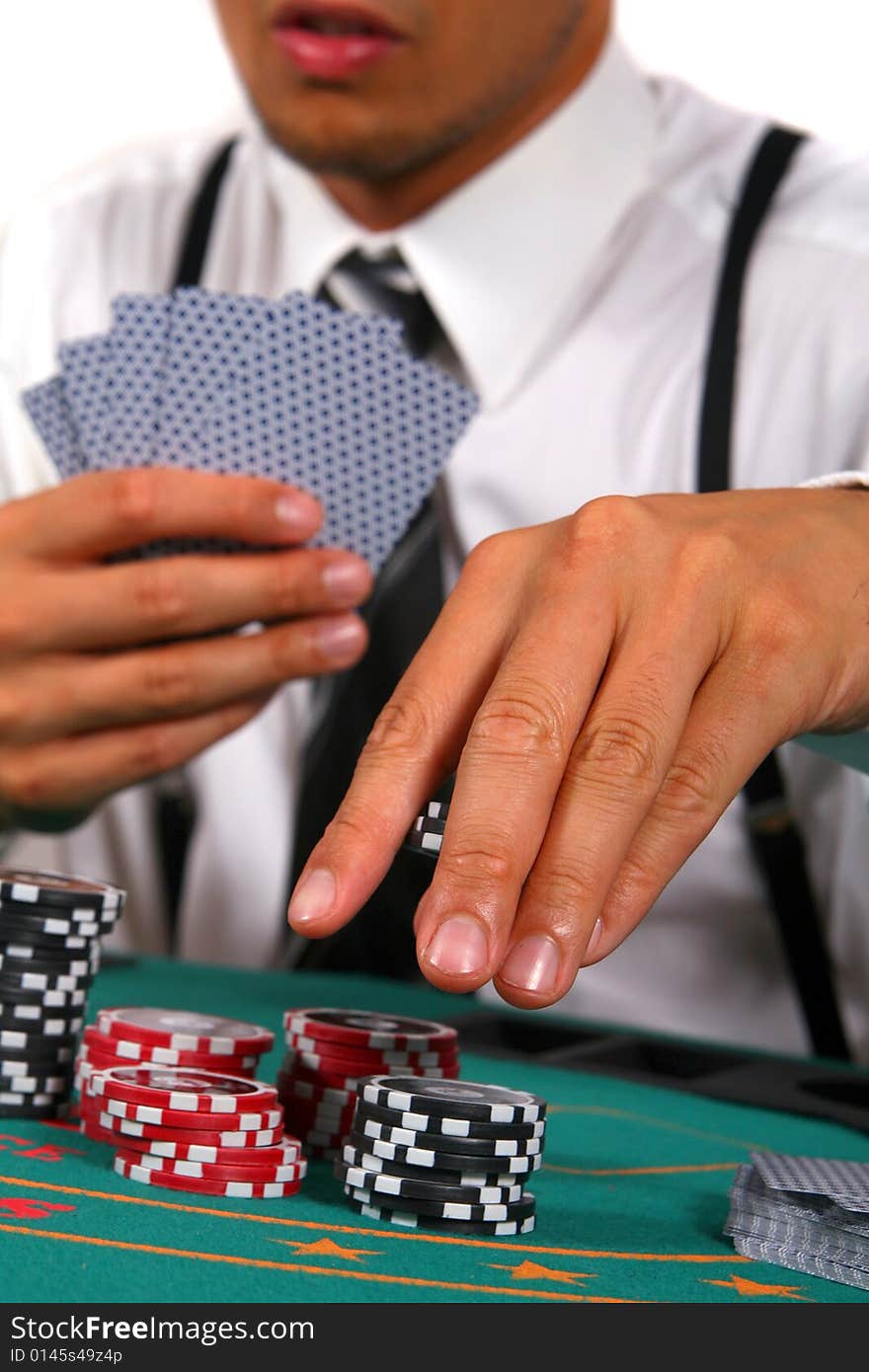 Young man playing poker. He is holding cards and chips in his hands. Isolated over white background. Young man playing poker. He is holding cards and chips in his hands. Isolated over white background.