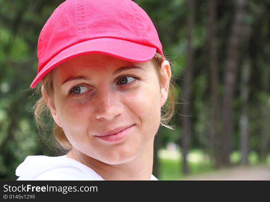 Portrait of smiling young woman in a red cap