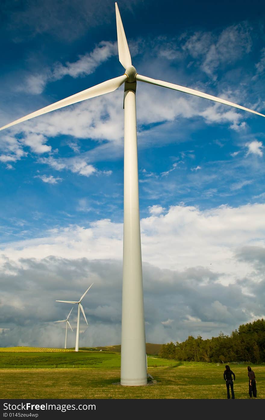 Beautiful green meadow with Wind turbines generating electricity. Beautiful green meadow with Wind turbines generating electricity