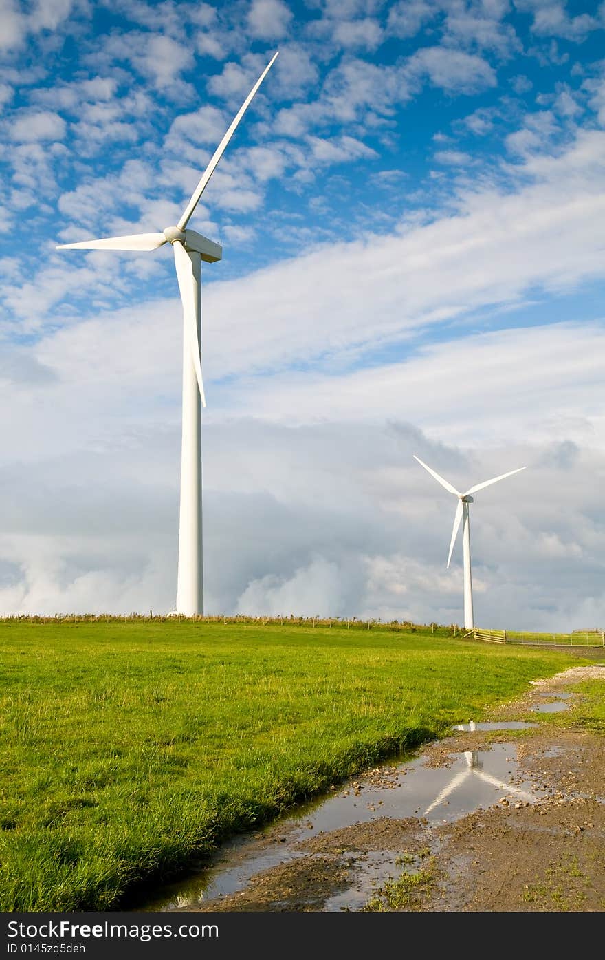 Beautiful green meadow with Wind turbines generating electricity. Beautiful green meadow with Wind turbines generating electricity