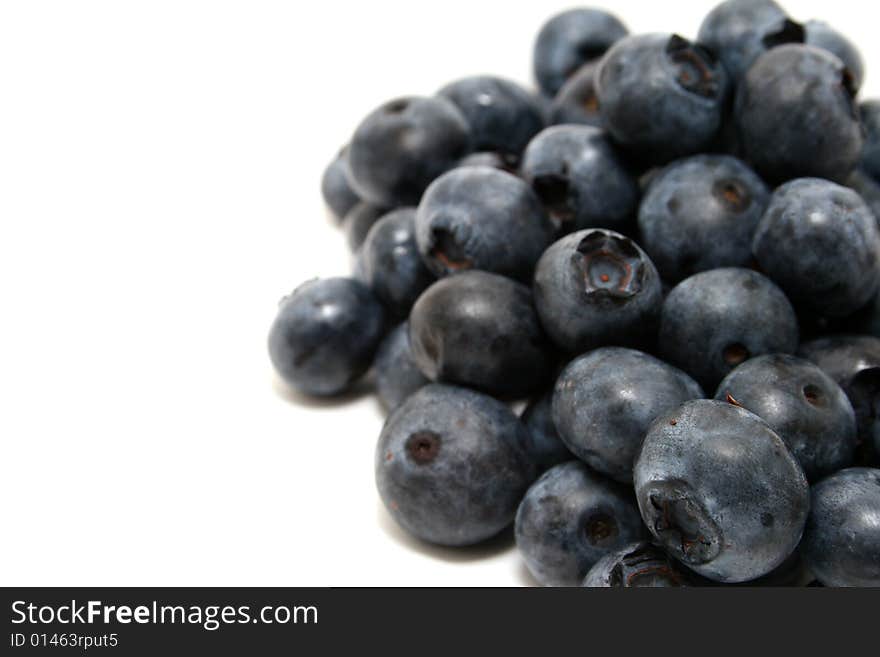 A group of blueberries isolated with a white background. A group of blueberries isolated with a white background.