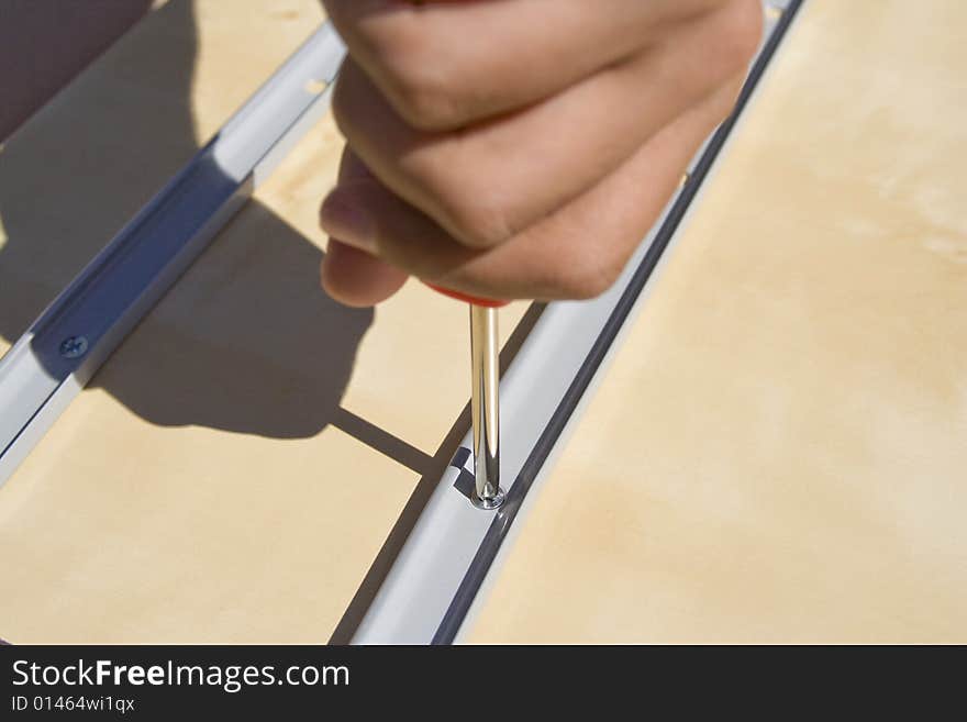 Hand using a screwdriver. Horizontally framed photo. Hand using a screwdriver. Horizontally framed photo.