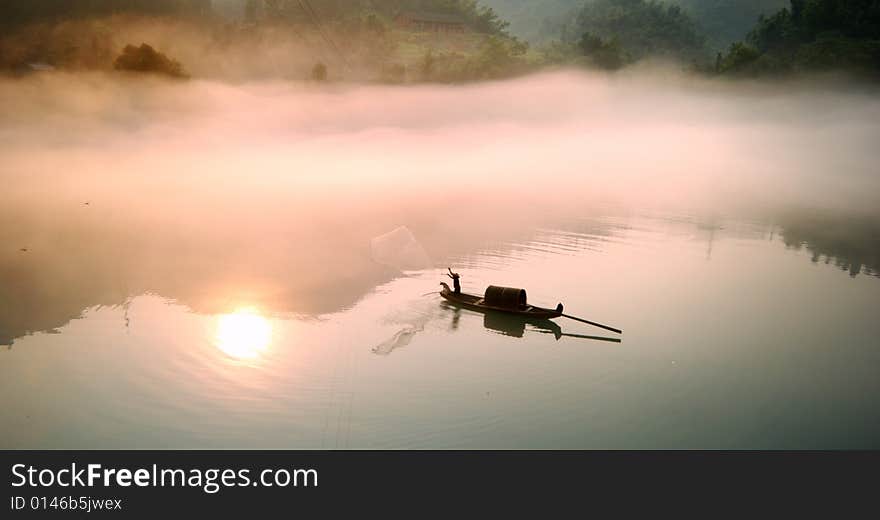 Picture is of a Foggy morning along Lost River,one fisherman and one dog in small raft. Picture is of a Foggy morning along Lost River,one fisherman and one dog in small raft.