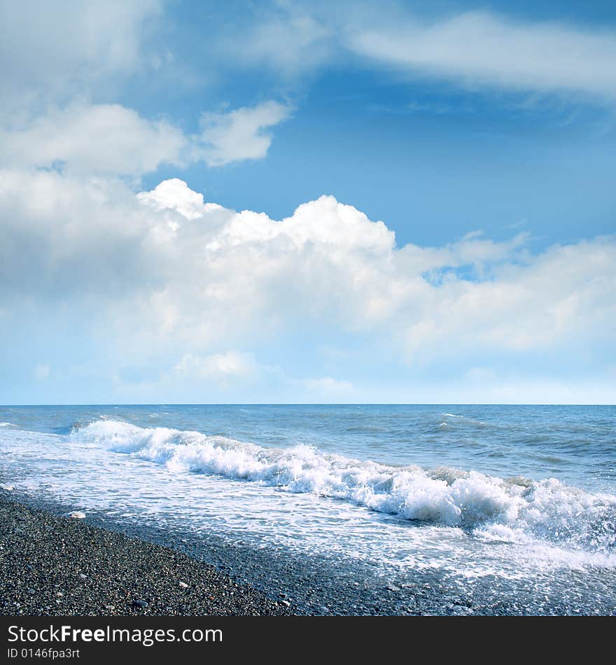 Wave on sea beach under year blue sky and cloud