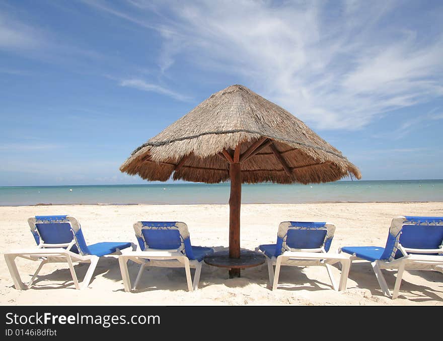 Beach scenic with lounge chairs and umbrella. Beach scenic with lounge chairs and umbrella