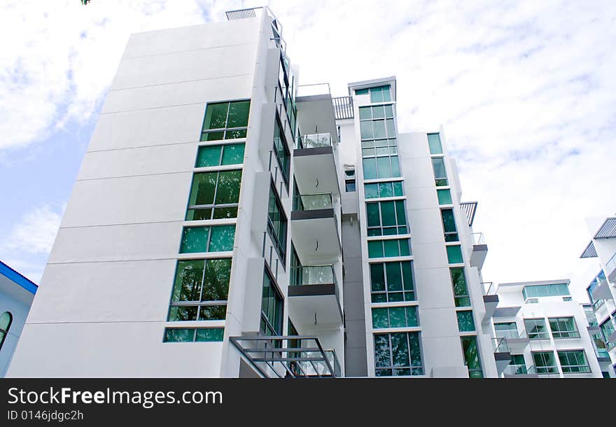 New tropical house exterior against blue sky. New tropical house exterior against blue sky