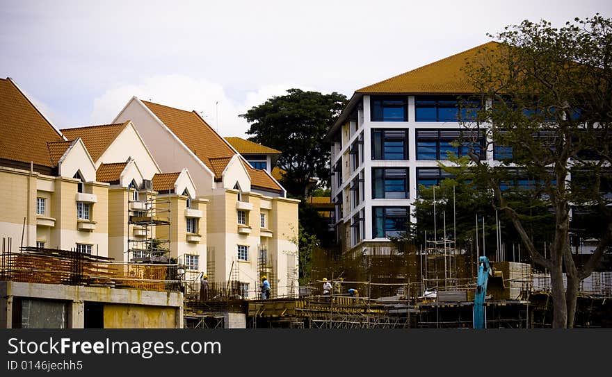 Construction site near private house with red roof