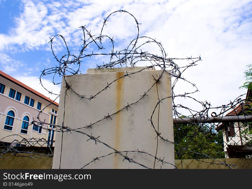 Steel security barrier to top of wall