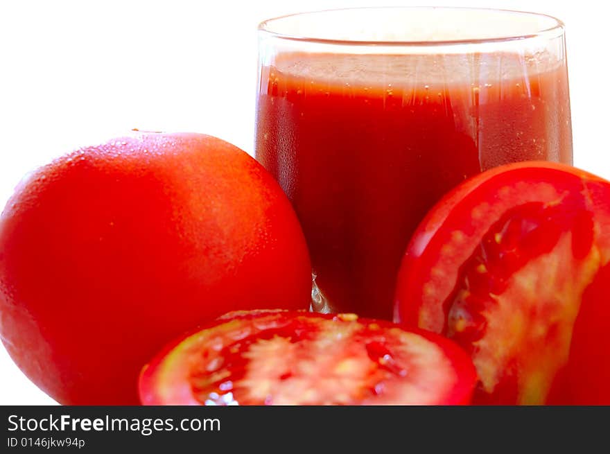 Fresh Tomato Juice In Glass And Tomatoes.