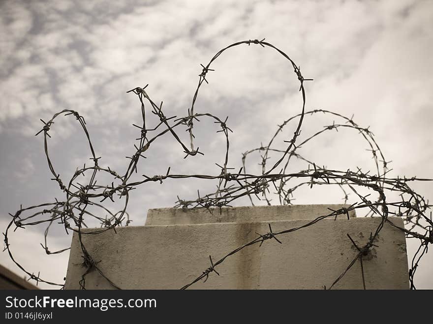 Steel security barrier to top of wall