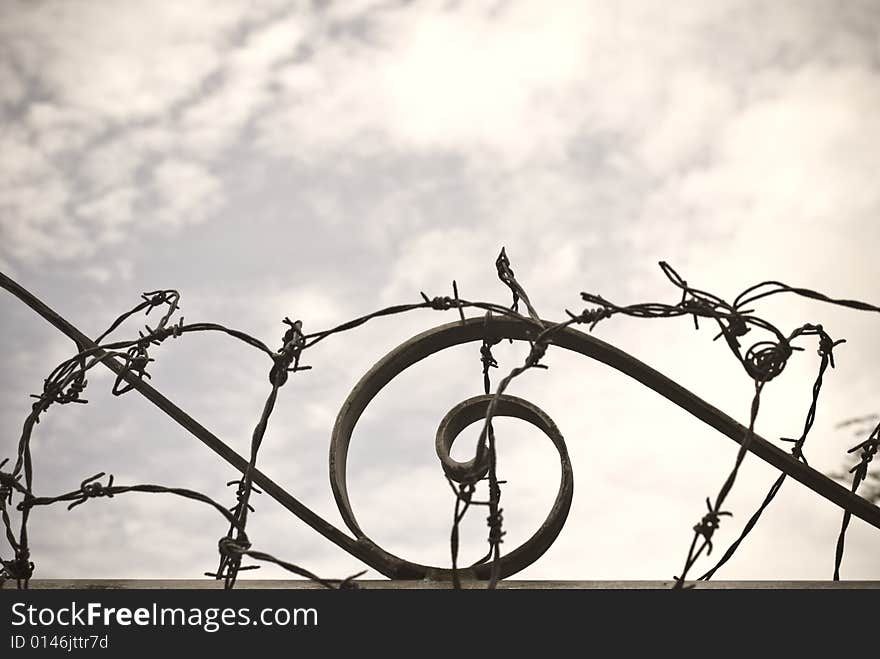 Steel security barrier to top of wall