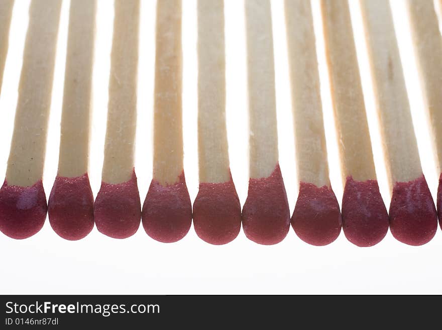 Row of matchsticks isolated on white backgroud. Row of matchsticks isolated on white backgroud