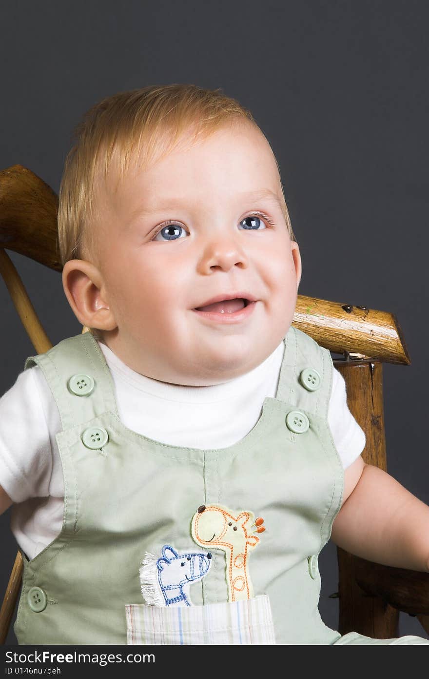 Baby Boy wearing a pastel dungaree and white shirt