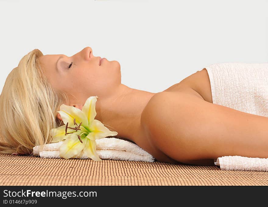 Young woman relaxing in spa area,dreaming.Isolated on white. Young woman relaxing in spa area,dreaming.Isolated on white.