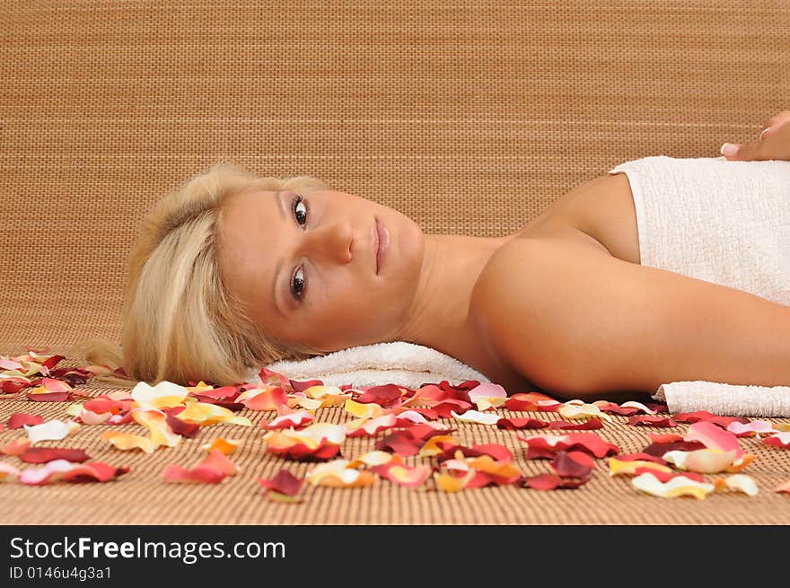 Young woman lying on a massage table,enjoying a aroma therapy. Young woman lying on a massage table,enjoying a aroma therapy.