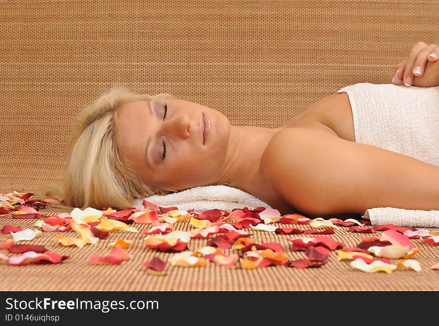 Young woman lying on a massage table,enjoying a aroma therapy. Young woman lying on a massage table,enjoying a aroma therapy.