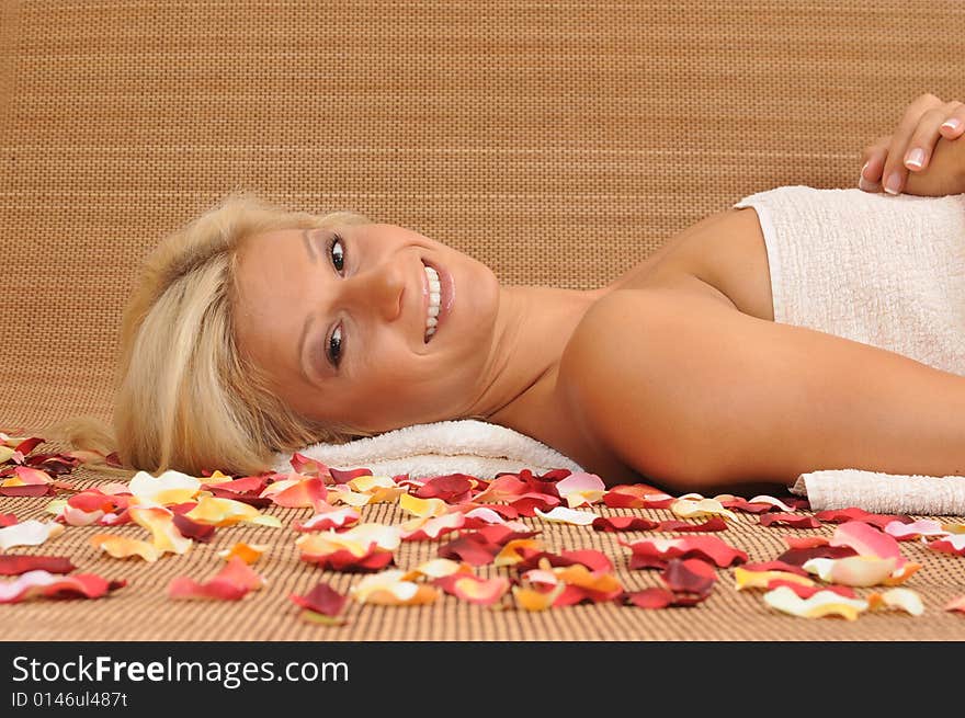 Young woman lying on a massage table,enjoying a aroma therapy. Young woman lying on a massage table,enjoying a aroma therapy.