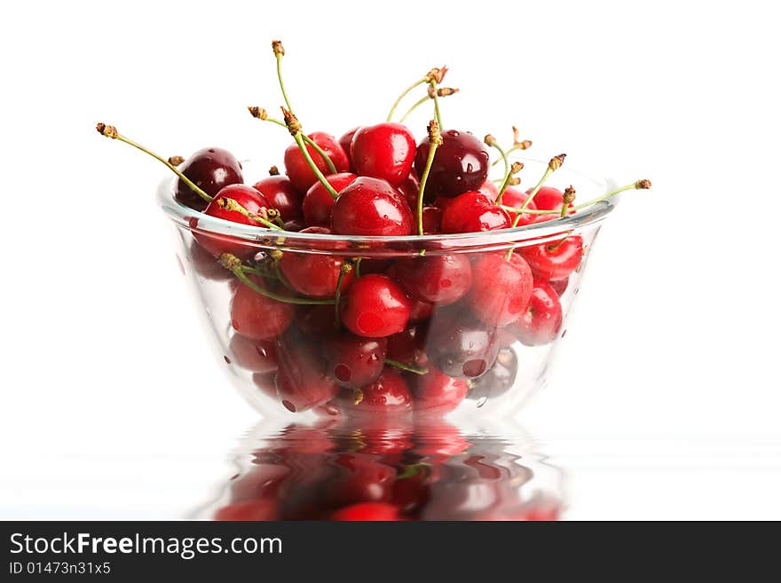 An image of red berries in a glass close up