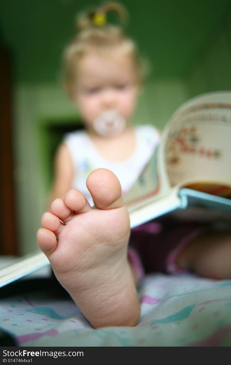 An image of a baby reading a book. An image of a baby reading a book