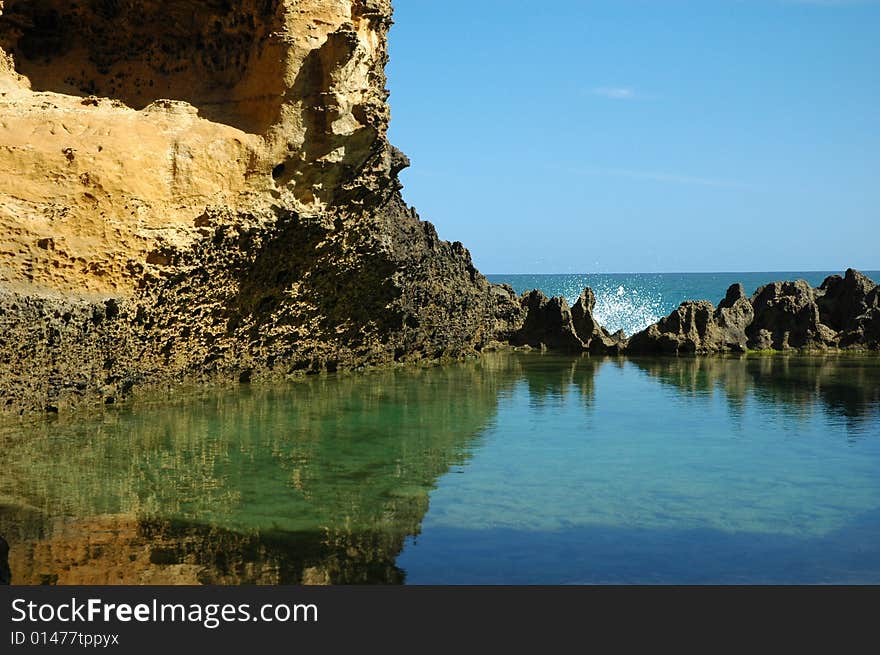 A pool resides just before the ocean. A pool resides just before the ocean