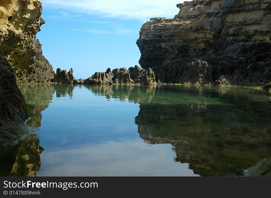 A pool resides just before the ocean. A pool resides just before the ocean