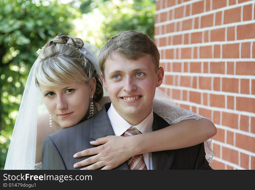 Happy newly-married couple on walk in park