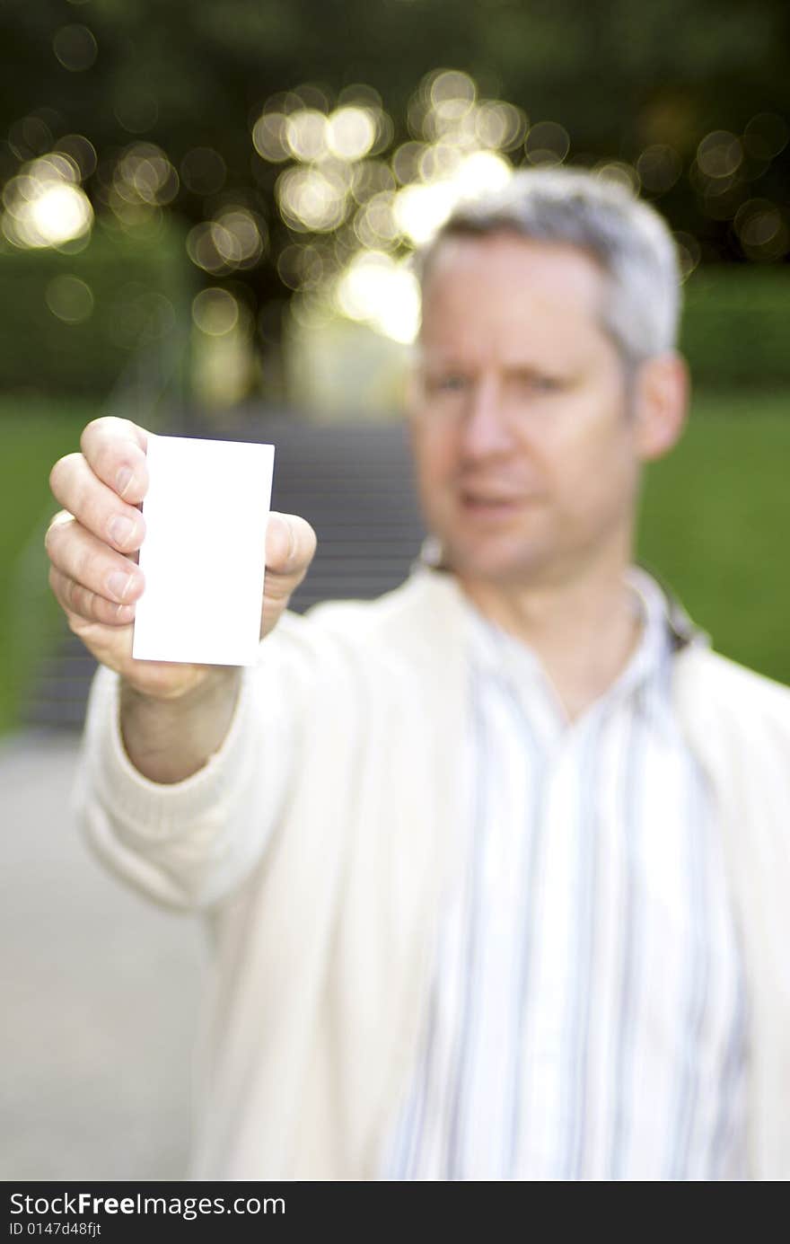 Young man holding a blank business card 1