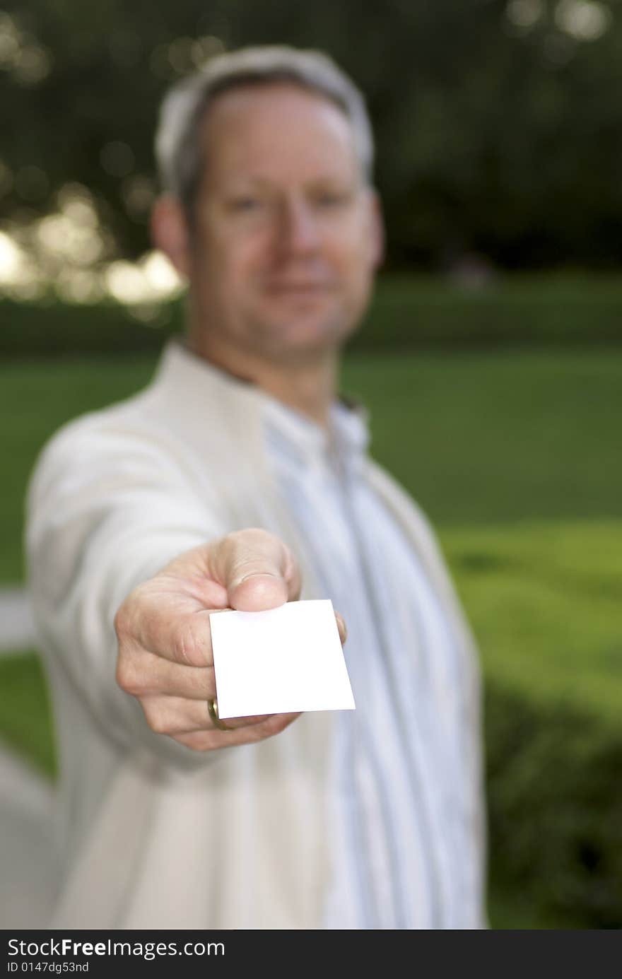 Young man giving a blank business card