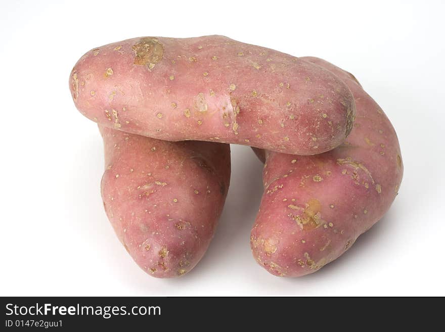 Three purple potatoes on white background