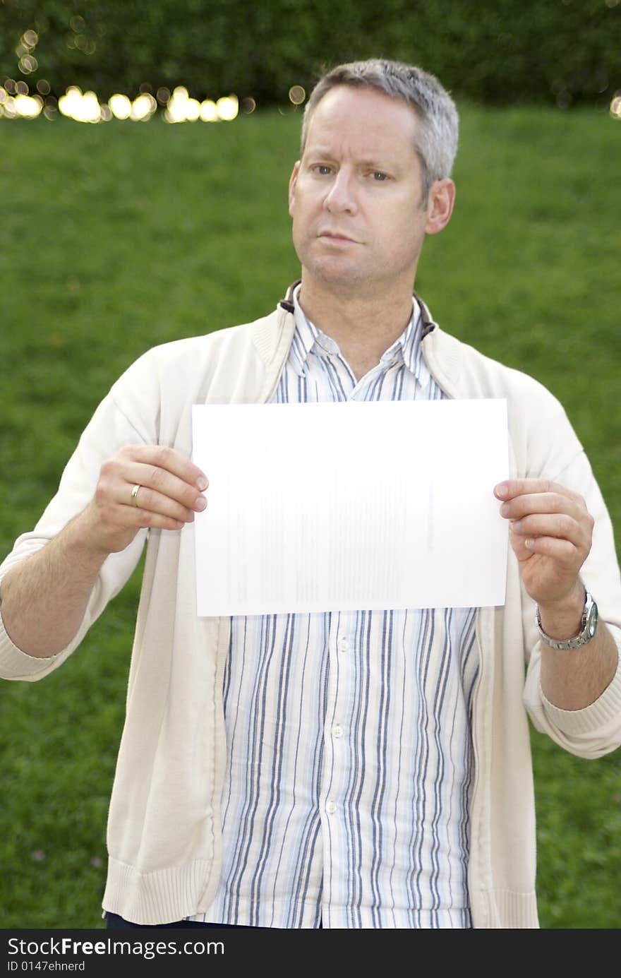 Young male standing and holding a blank sign. Young male standing and holding a blank sign