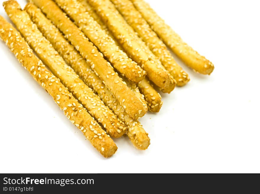 Many breadsticks with sesame - isolated on the whi