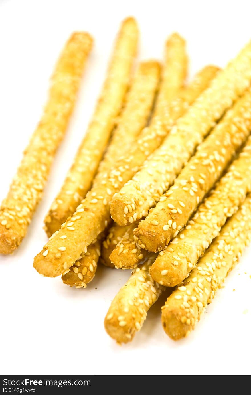 Many breadsticks with sesame - isolated on the whi