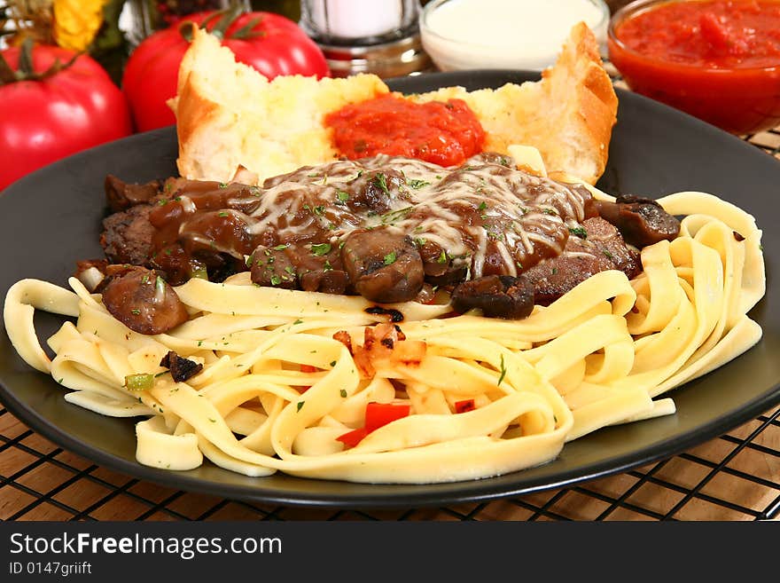 Thin slices of sirloin saut�ed with onions and peppers with creamy brown
gravy and mushrooms. Thin slices of sirloin saut�ed with onions and peppers with creamy brown
gravy and mushrooms.