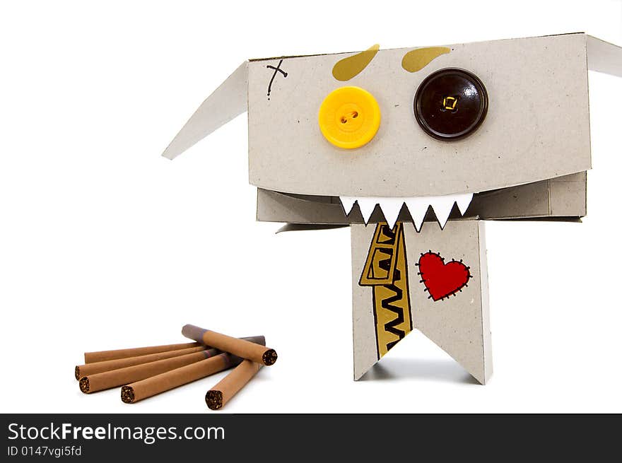 Brown cigarettes and funny expressive cardboard toy. Brown cigarettes and funny expressive cardboard toy