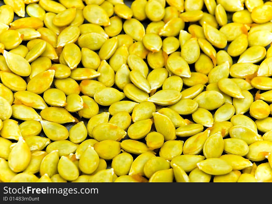 A close up shot of many pumpkin seeds