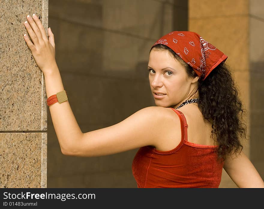 Portrait of pretty brunet woman  near column