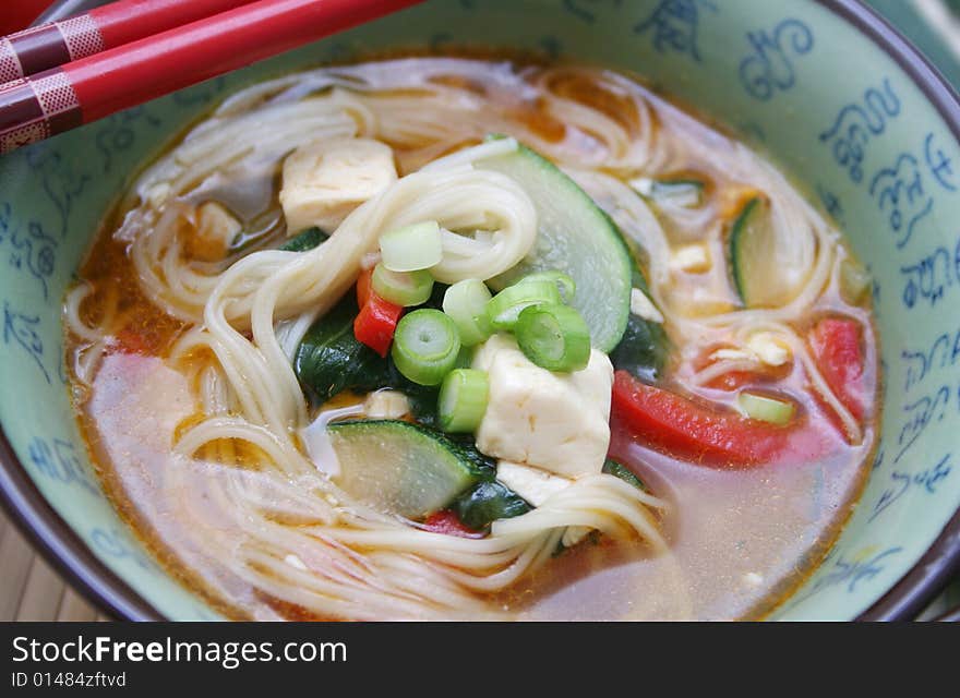 A japanese soup with vegetables and somen noodles. A japanese soup with vegetables and somen noodles