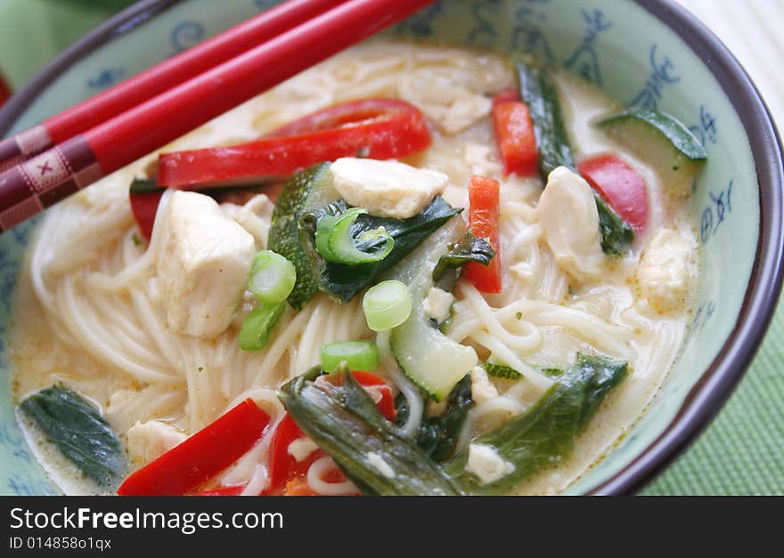 A asian meal with noodles, vegetables and tofu. A asian meal with noodles, vegetables and tofu