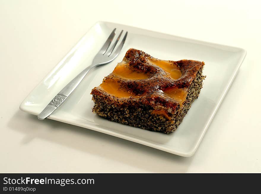 A view with a piece of cake over white background