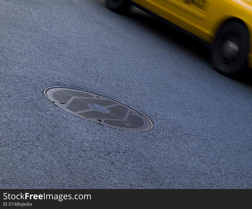 A New York yellow cab running beside a culvert. A New York yellow cab running beside a culvert.