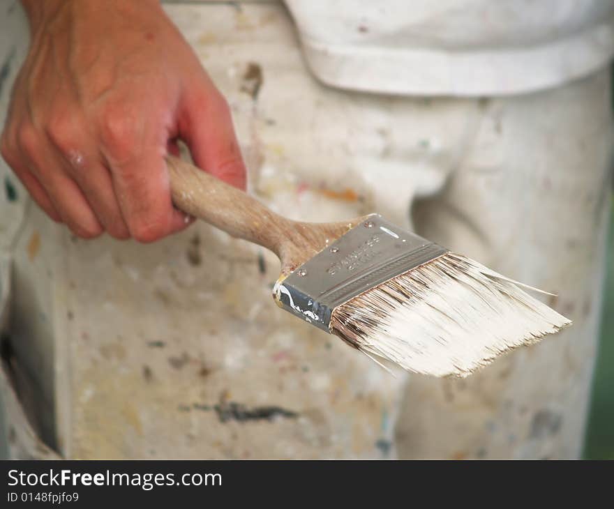 The picture of young painter who is holding a brush. The picture of young painter who is holding a brush