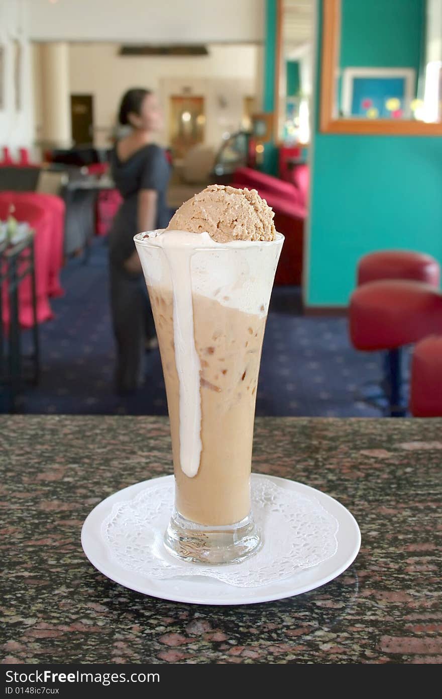 Mocha coffee ice cream, waitress at background. Mocha coffee ice cream, waitress at background