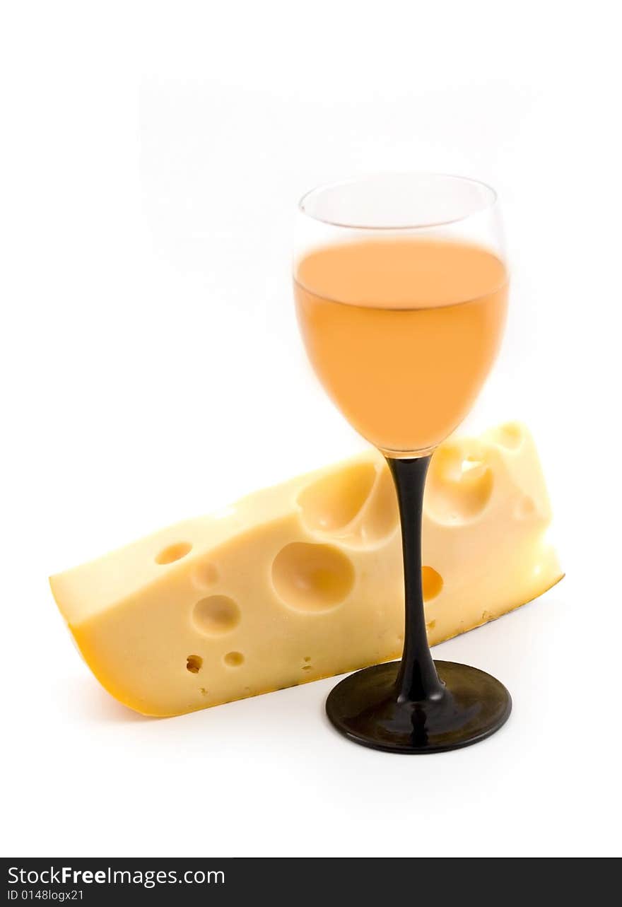 Yellow cheese with 
apertures and a wine-glass with wine on a white background