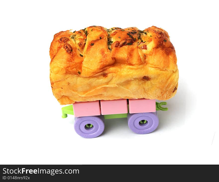 The bread with dried meat on the toy wheels. The bread with dried meat on the toy wheels.