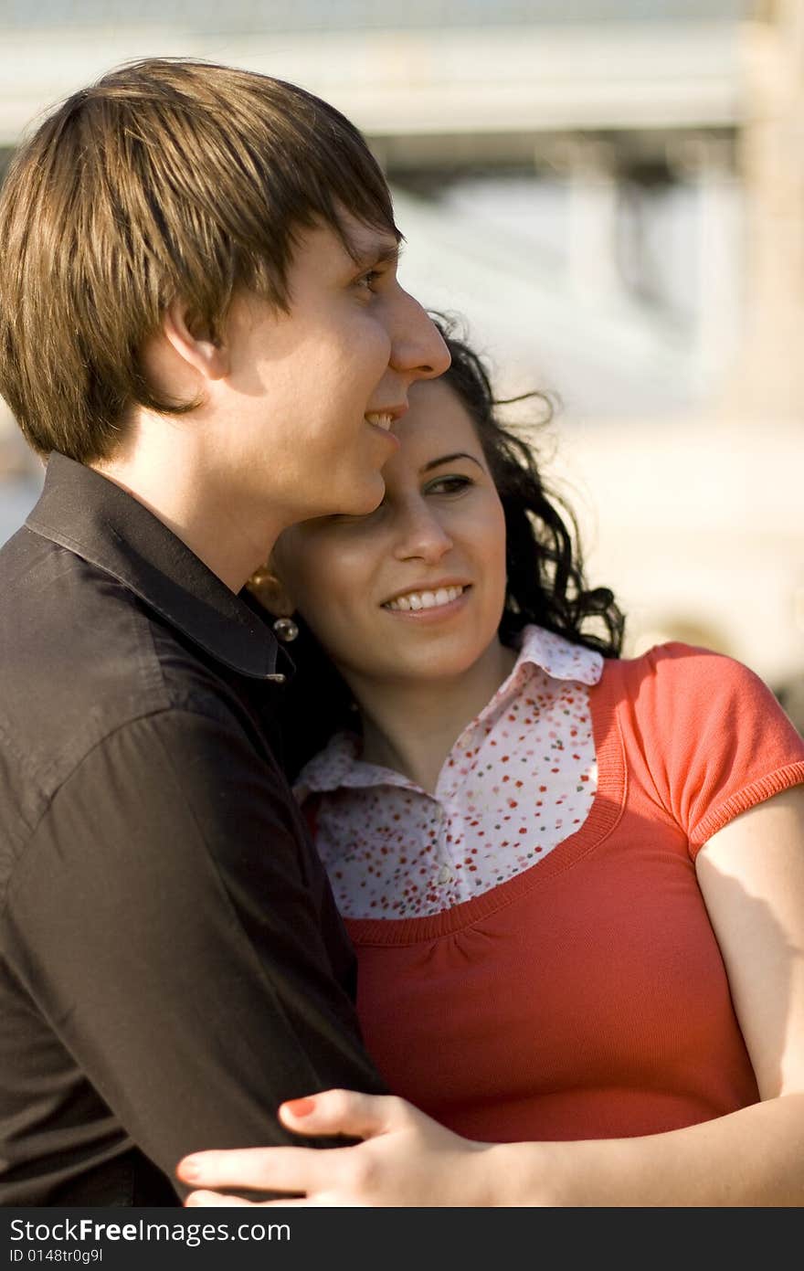 Outdoor portrait of young happy attractive couple together