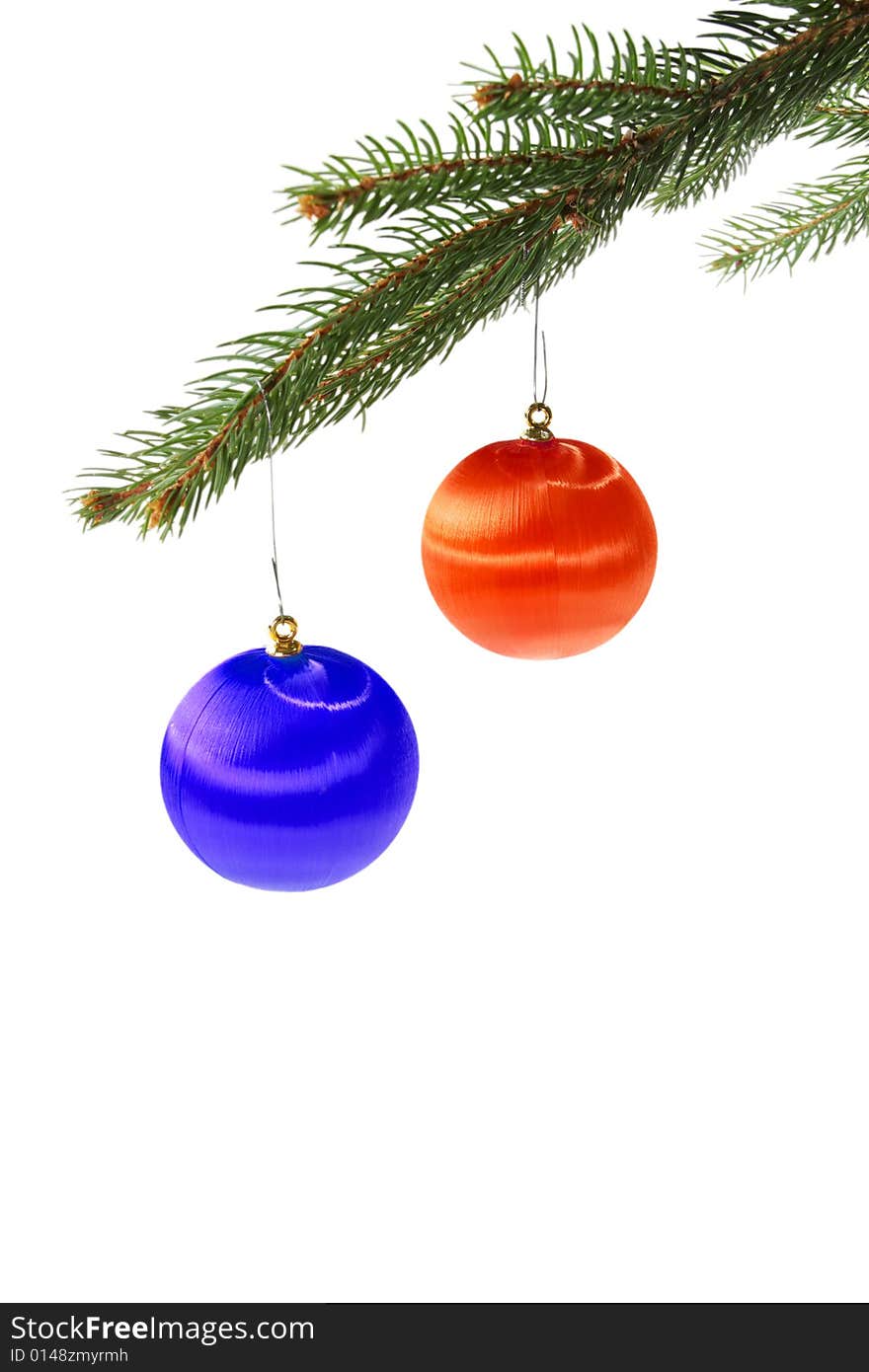 Red and blue christmas balls on spruce branch isolated on white. Red and blue christmas balls on spruce branch isolated on white