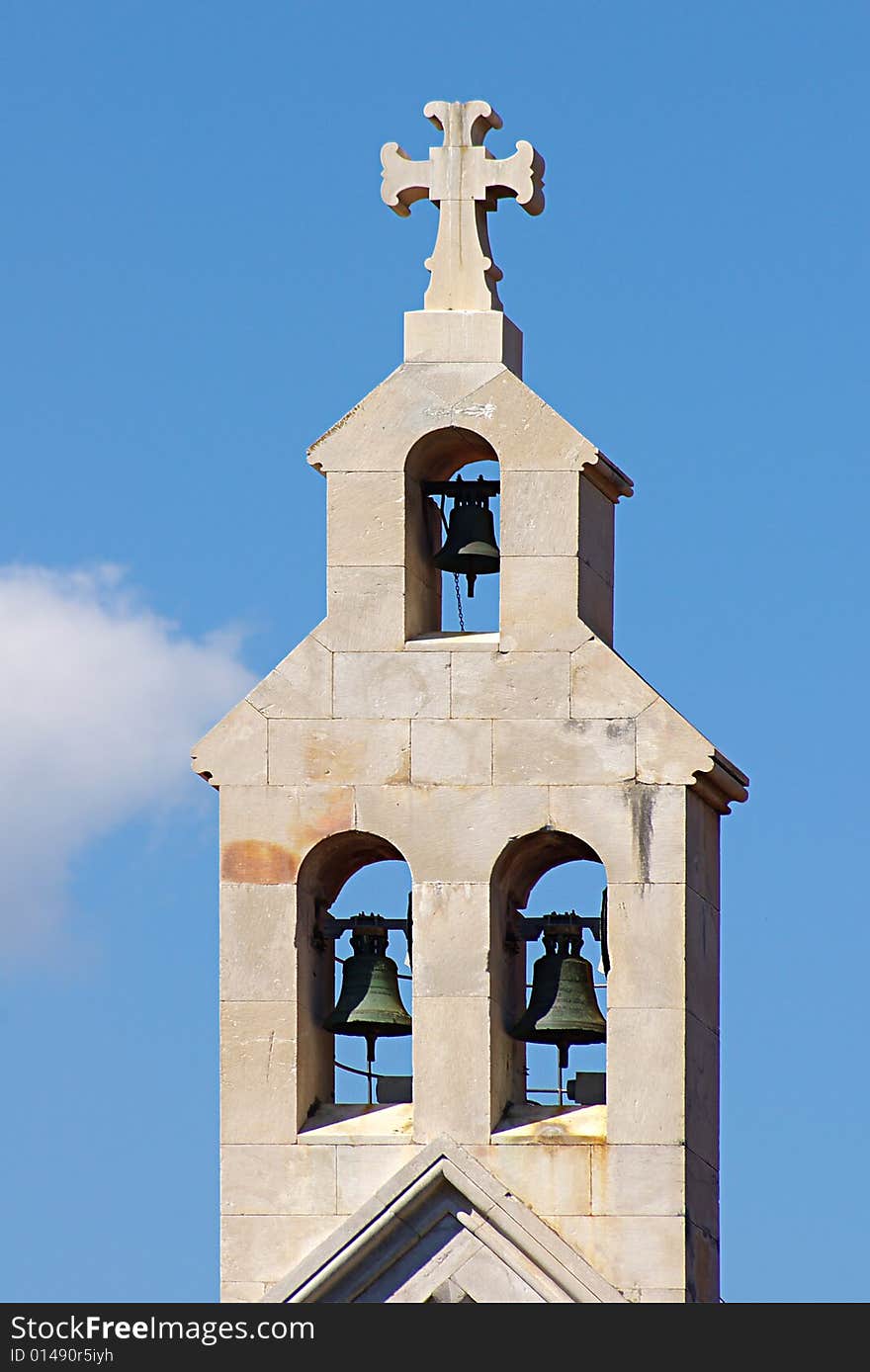 Belltower on a background of the blue sky.