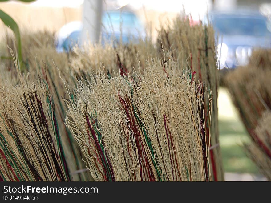 A worker creates an old fashioned broom. A worker creates an old fashioned broom.