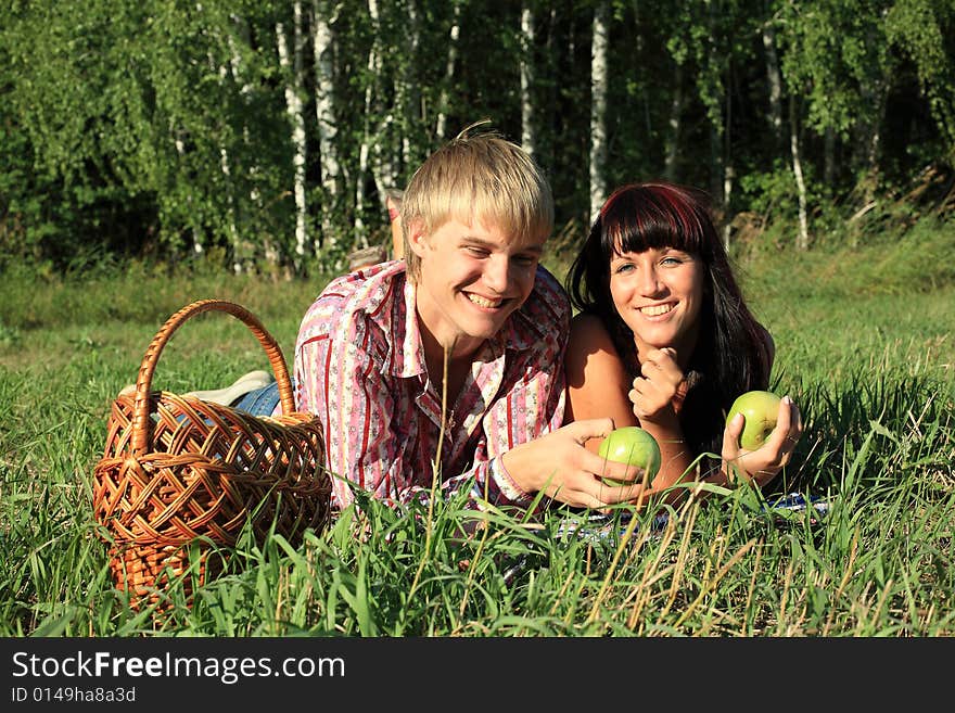 Beautiful couple lying on the grass. Beautiful couple lying on the grass